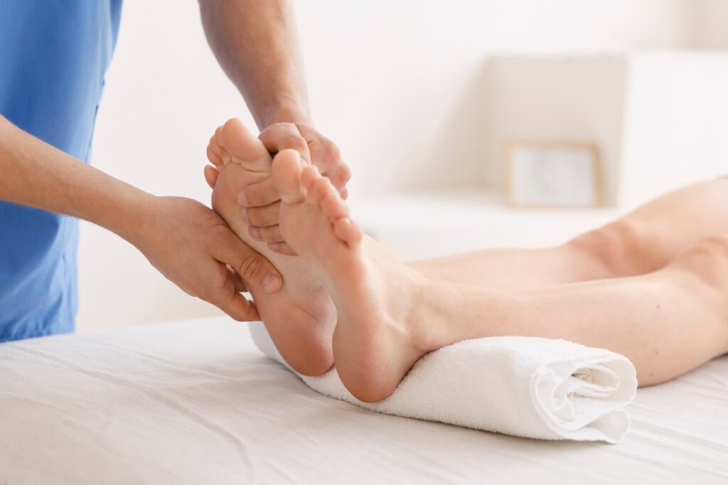 Doctor with patient at foot massage session