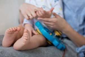 Close up parent holding baby